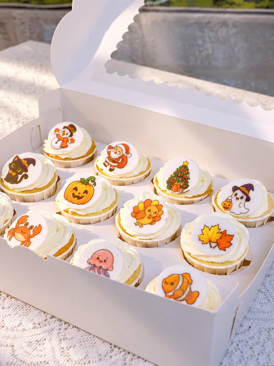 Cupcakes with colorful printed toppers featuring holiday and animal designs.